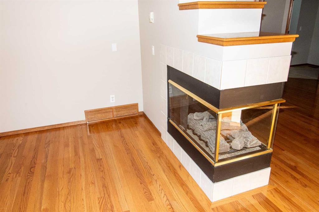 16 Eagleview Heights Nw, Cochrane, AB - Indoor Photo Showing Other Room With Fireplace