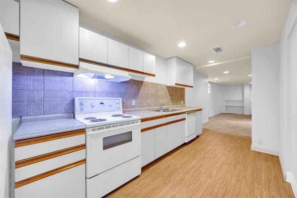 49 Beacham Way Nw, Calgary, AB - Indoor Photo Showing Kitchen With Double Sink