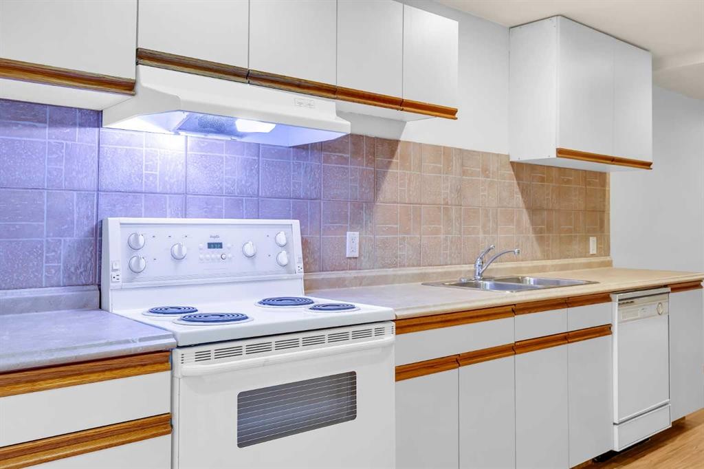 49 Beacham Way Nw, Calgary, AB - Indoor Photo Showing Kitchen With Double Sink