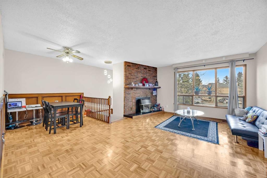 49 Beacham Way Nw, Calgary, AB - Indoor Photo Showing Living Room With Fireplace