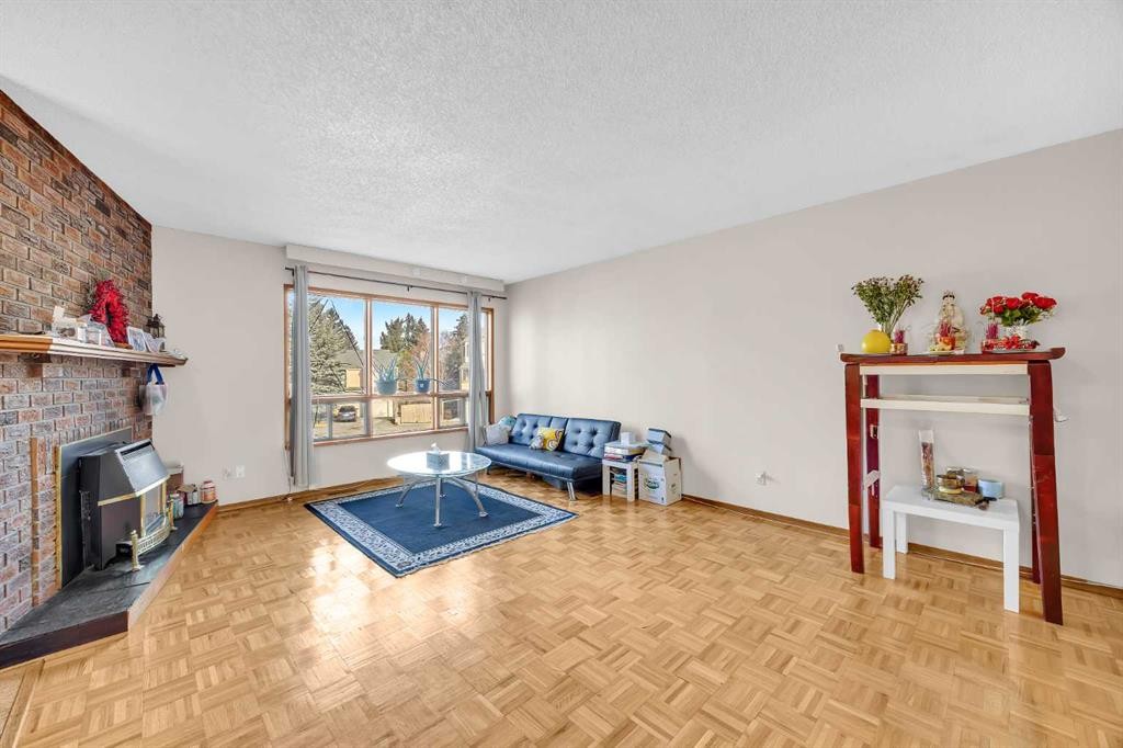 49 Beacham Way Nw, Calgary, AB - Indoor Photo Showing Living Room With Fireplace