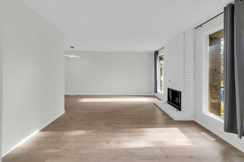 10 Radcliffe Crescent Se, Calgary, AB - Indoor Photo Showing Other Room With Fireplace