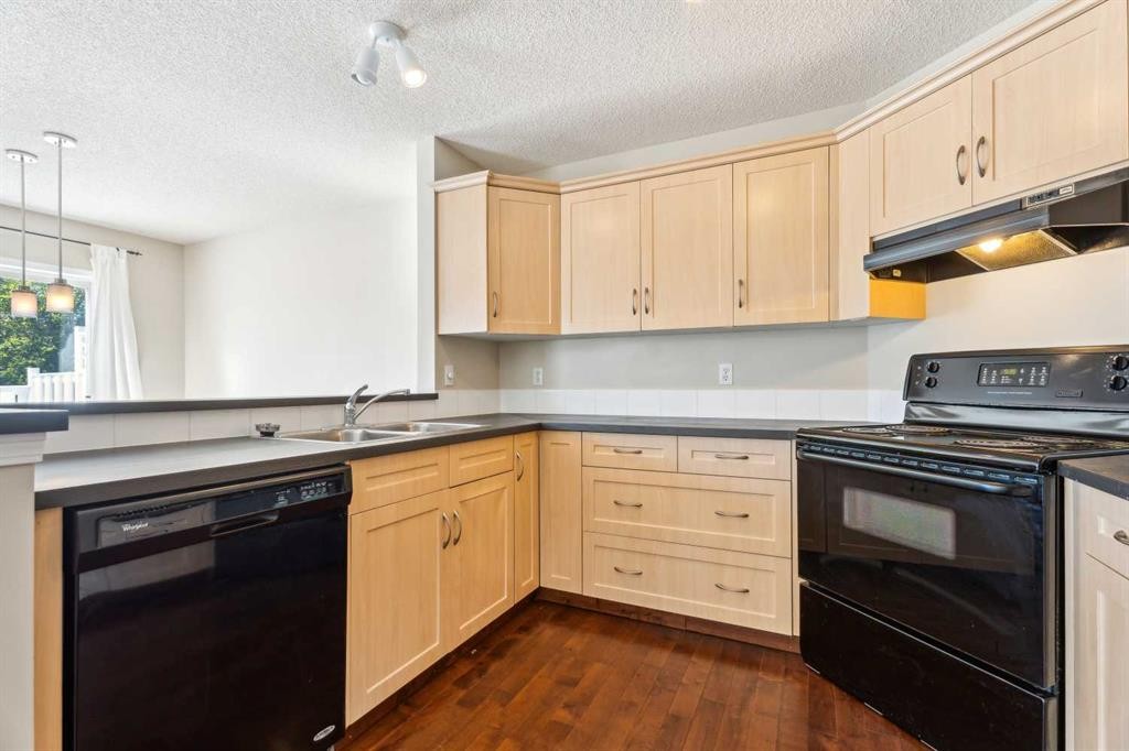 73 Rocky Ridge Heath Nw, Calgary, AB - Indoor Photo Showing Kitchen With Double Sink