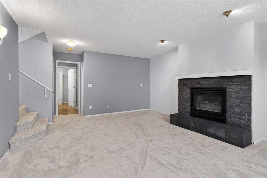 328 Douglas Ridge Close Se, Calgary, AB - Indoor Photo Showing Living Room With Fireplace