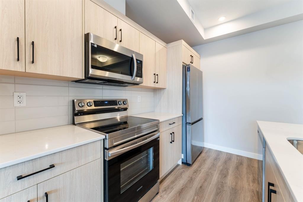 2312-55 Lucas Way Nw, Calgary, AB - Indoor Photo Showing Kitchen With Stainless Steel Kitchen With Upgraded Kitchen
