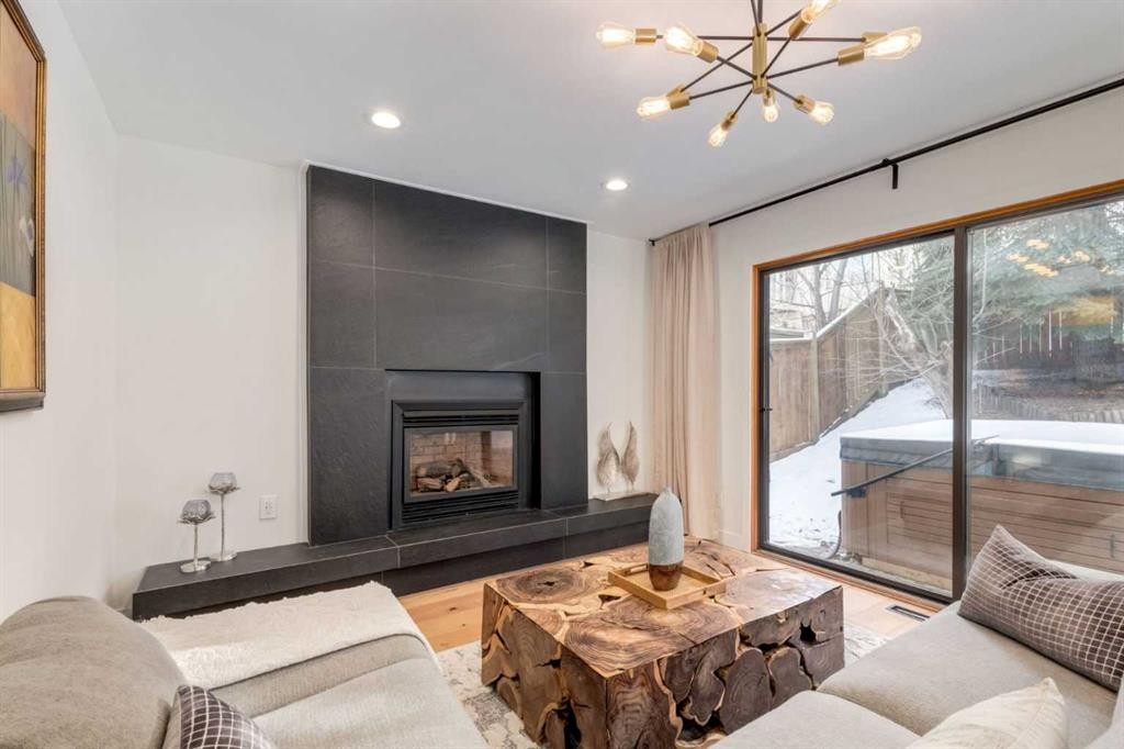 113 Straddock Terrace Sw, Calgary, AB - Indoor Photo Showing Living Room With Fireplace