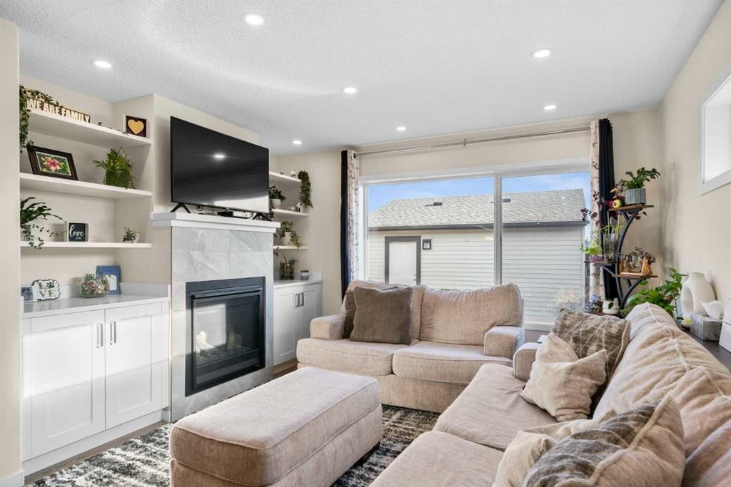 17 Cranford Place Se, Calgary, AB - Indoor Photo Showing Living Room With Fireplace