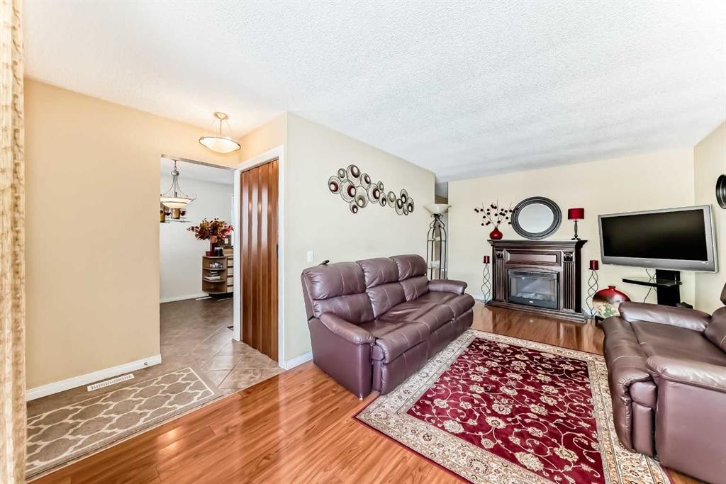 208 Bracewood Road Sw, Calgary, AB - Indoor Photo Showing Living Room With Fireplace