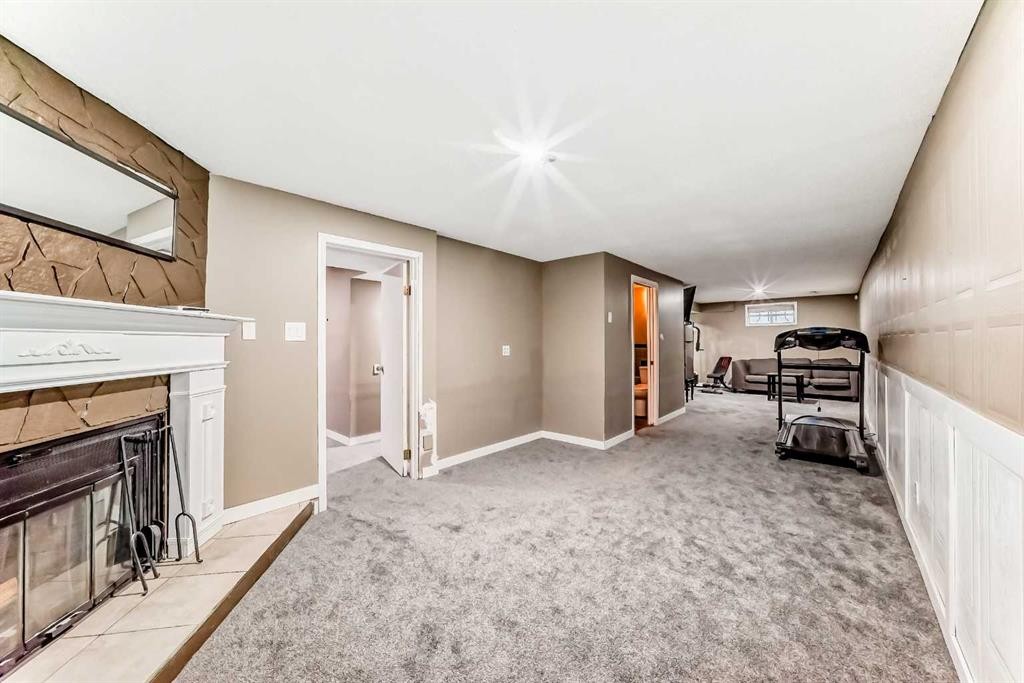 707 Malvern Drive Ne, Calgary, AB - Indoor Photo Showing Other Room With Fireplace