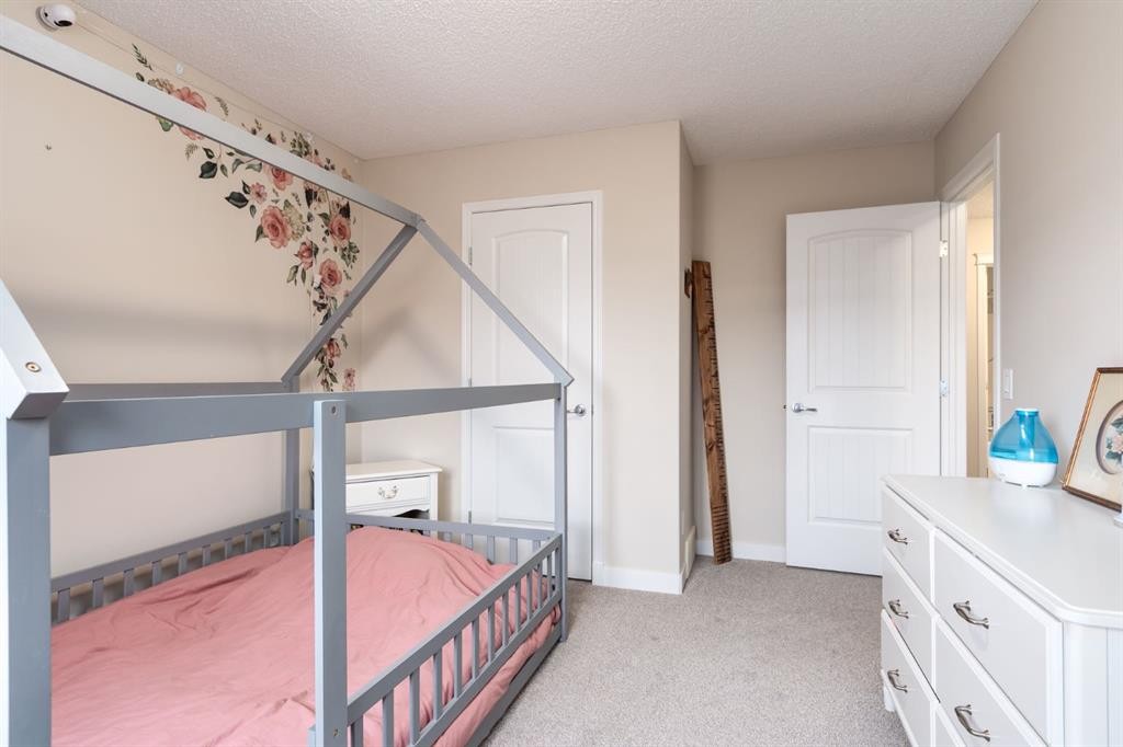 128 Seagreen Manor, Chestermere, AB - Indoor Photo Showing Bedroom