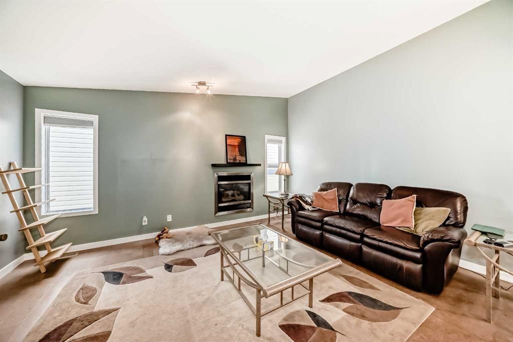 26 Copperfield View Se, Calgary, AB - Indoor Photo Showing Living Room With Fireplace