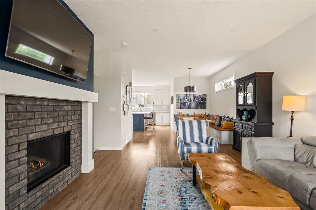 63 Seton Gardens Se, Calgary, AB - Indoor Photo Showing Living Room With Fireplace