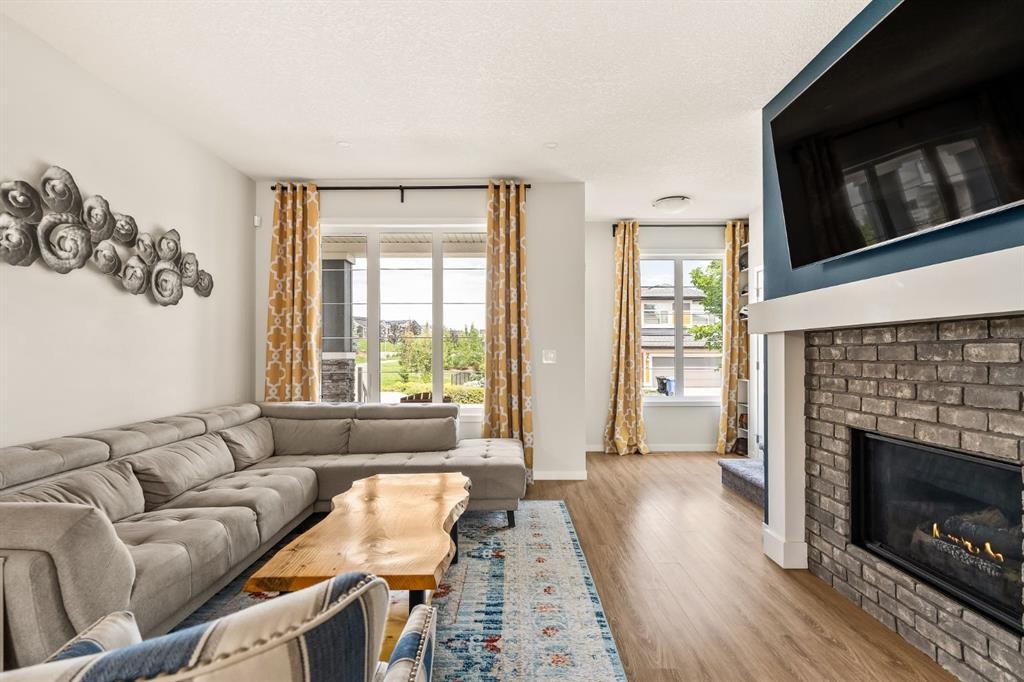63 Seton Gardens Se, Calgary, AB - Indoor Photo Showing Living Room With Fireplace
