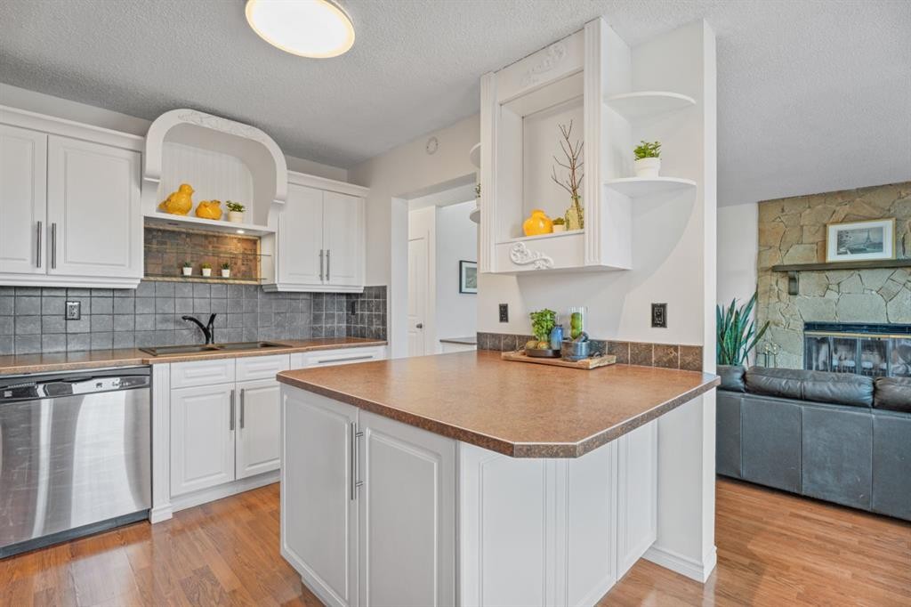 164 Beddington Circle Ne, Calgary, AB - Indoor Photo Showing Kitchen With Fireplace With Double Sink