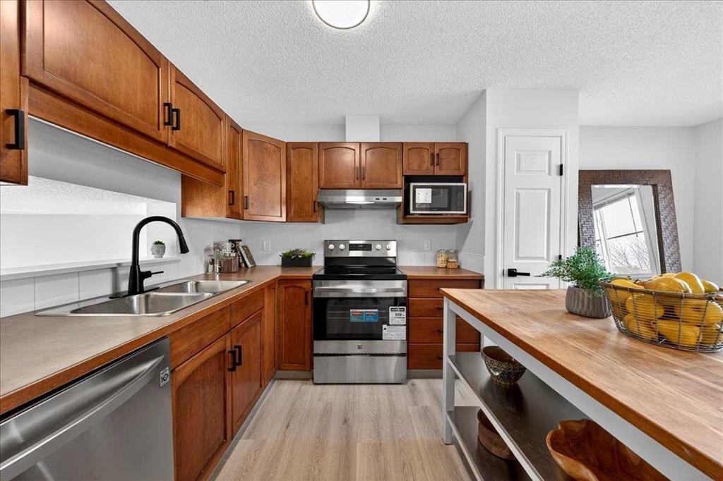 11 Copperfield Court Se, Calgary, AB - Indoor Photo Showing Kitchen With Double Sink