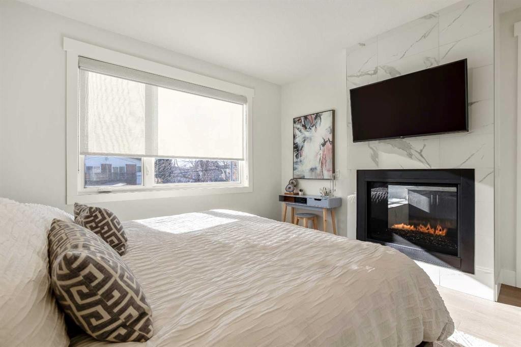 303 30 Avenue Ne, Calgary, AB - Indoor Photo Showing Bedroom With Fireplace