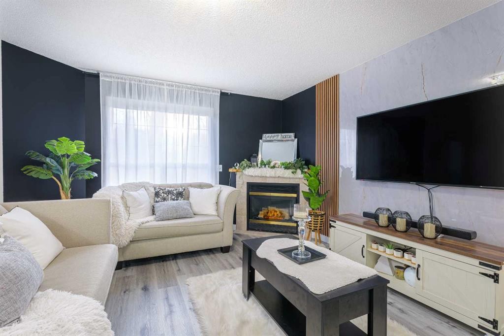 13 Mt. Aberdeen Manor Se, Calgary, AB - Indoor Photo Showing Living Room With Fireplace