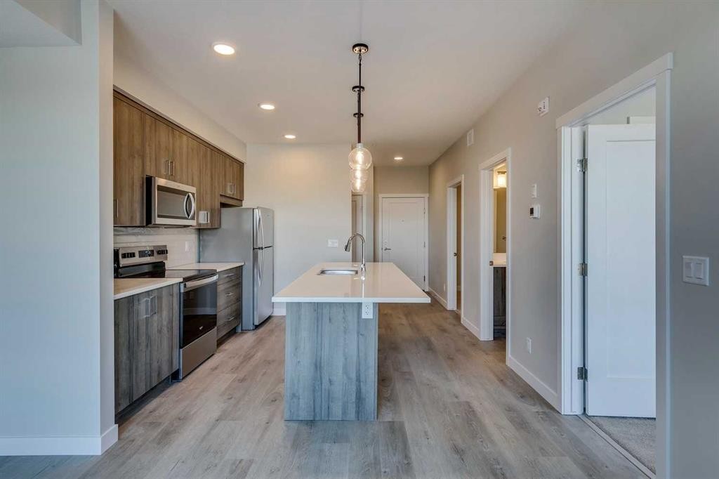 408-660 Shawnee Square Sw, Calgary, AB - Indoor Photo Showing Kitchen With Stainless Steel Kitchen