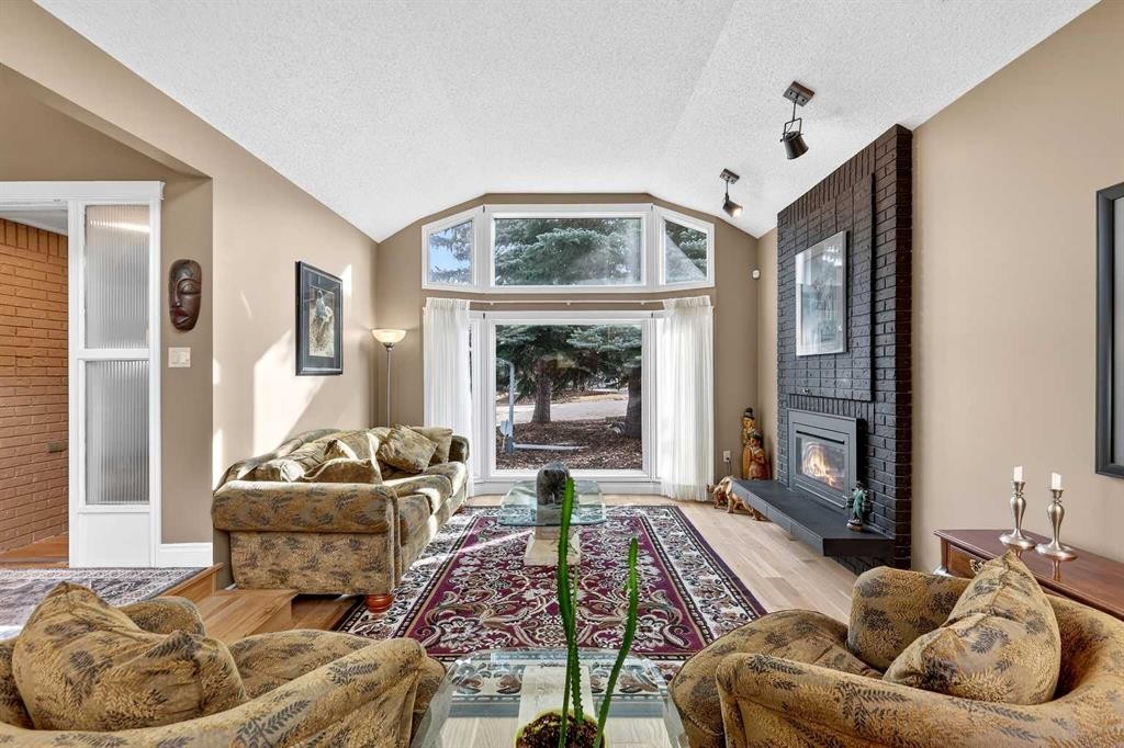 80 Oakmount Way Sw, Calgary, AB - Indoor Photo Showing Living Room With Fireplace