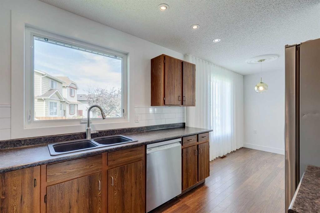23 Erin Grove Court Se, Calgary, AB - Indoor Photo Showing Kitchen With Double Sink