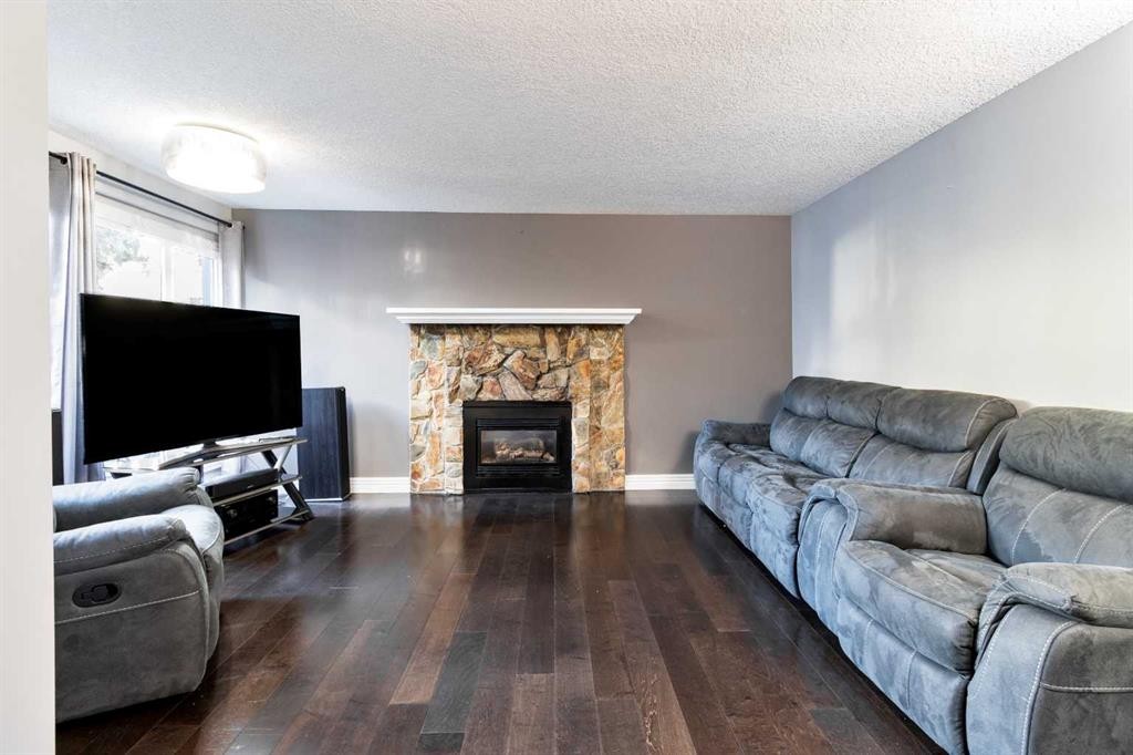 175-77 Glamis Green Sw, Calgary, AB - Indoor Photo Showing Living Room With Fireplace