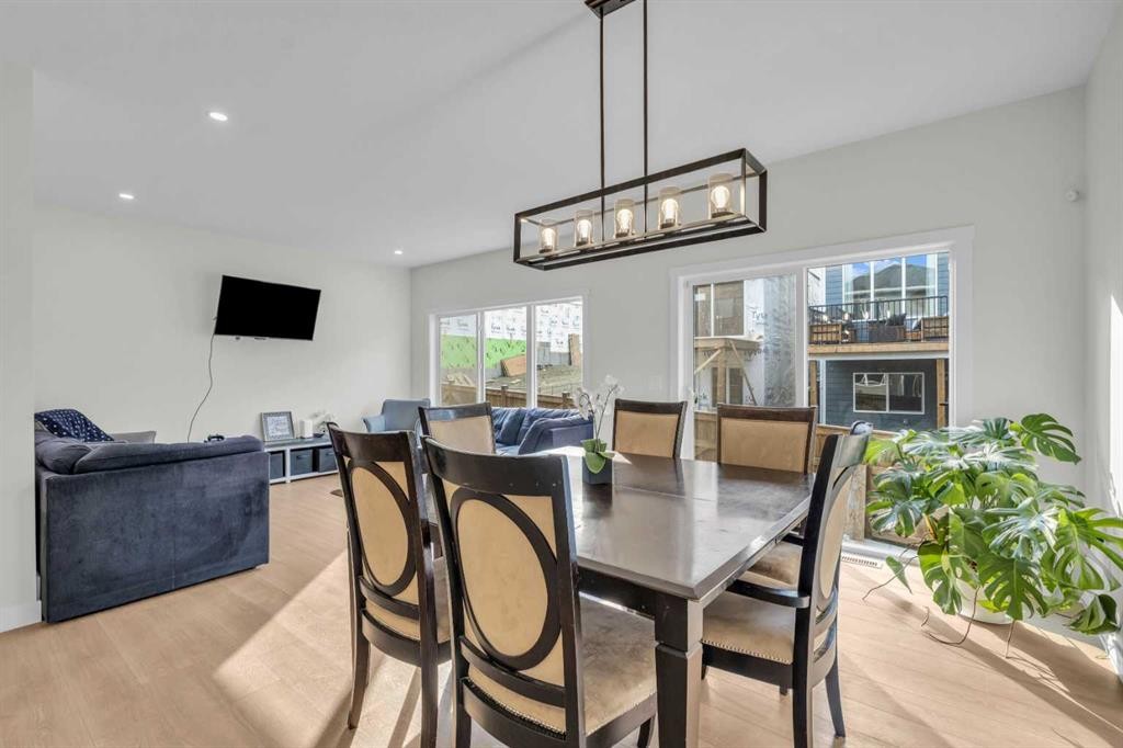 35 Versant View Sw, Calgary, AB - Indoor Photo Showing Dining Room With Fireplace