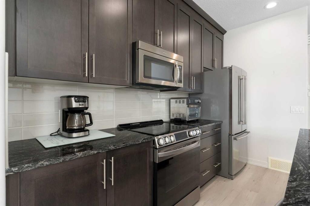 167 Fireside Drive, Cochrane, AB - Indoor Photo Showing Kitchen With Stainless Steel Kitchen