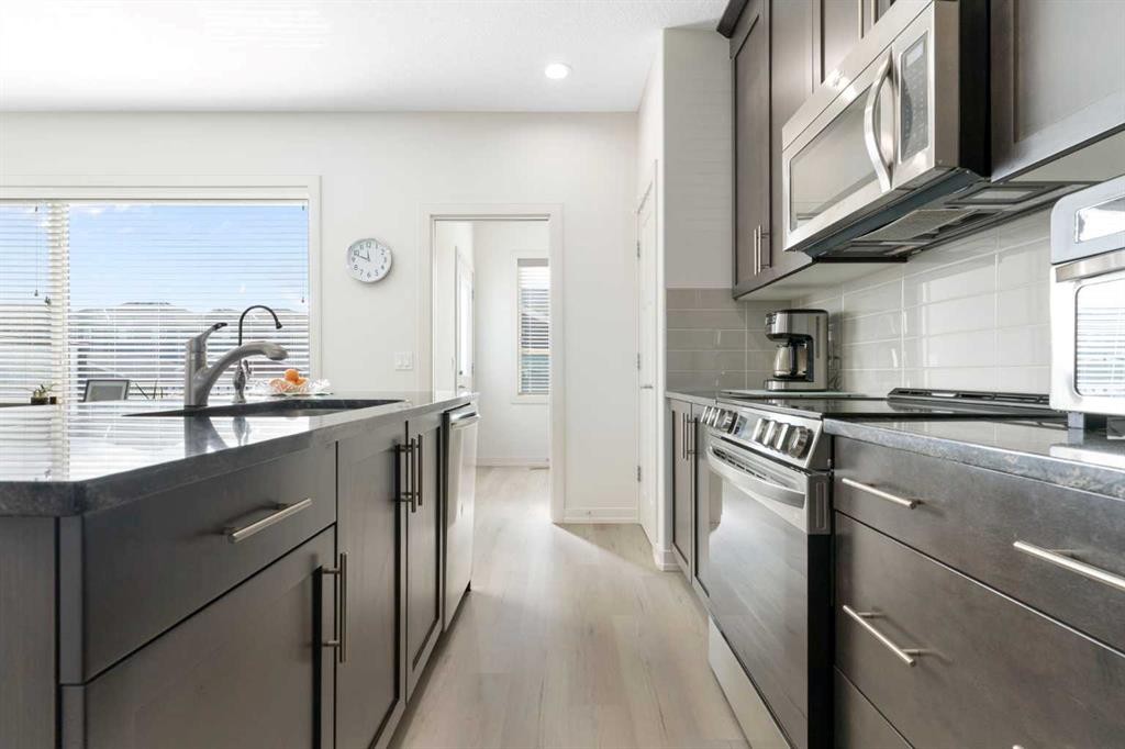 167 Fireside Drive, Cochrane, AB - Indoor Photo Showing Kitchen With Upgraded Kitchen
