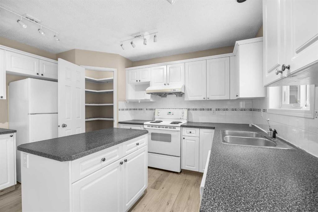 635 Panorama Hills Drive Nw, Calgary, AB - Indoor Photo Showing Kitchen With Double Sink