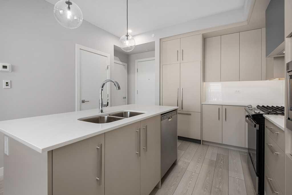 612-8230 Broadcast Avenue, Calgary, AB - Indoor Photo Showing Kitchen With Stainless Steel Kitchen With Double Sink With Upgraded Kitchen