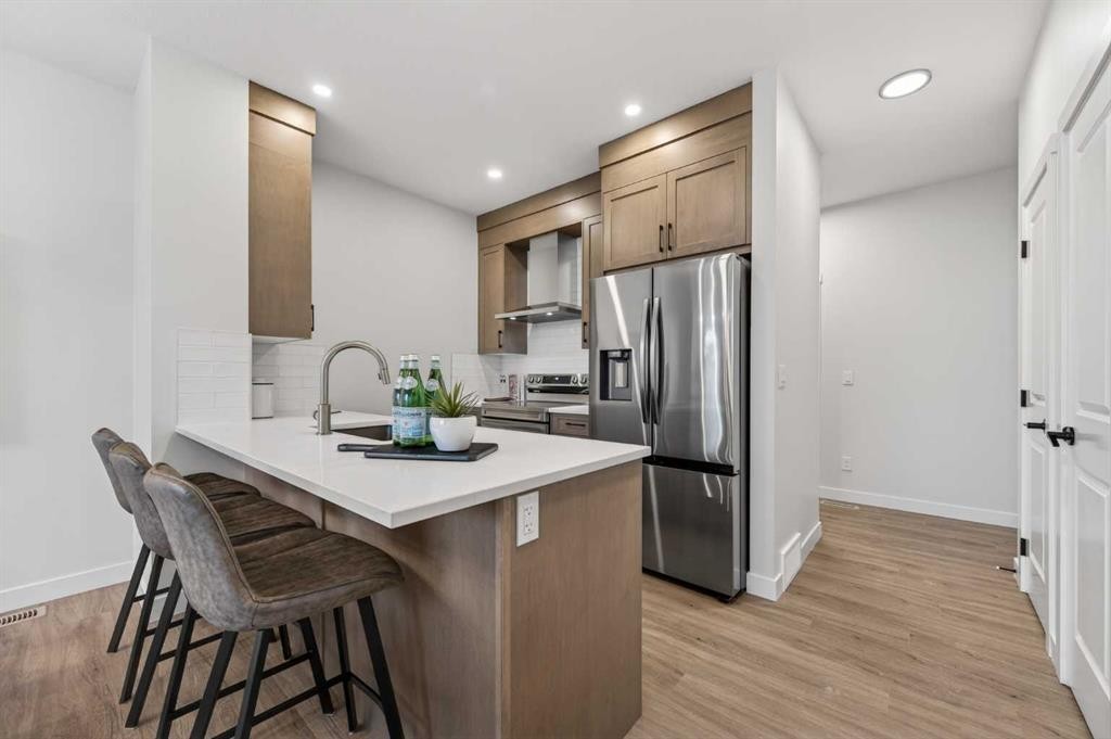 1051 Bayview Crescent, Airdrie, AB - Indoor Photo Showing Kitchen With Stainless Steel Kitchen With Upgraded Kitchen