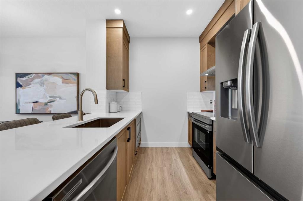 1051 Bayview Crescent, Airdrie, AB - Indoor Photo Showing Kitchen With Stainless Steel Kitchen With Upgraded Kitchen