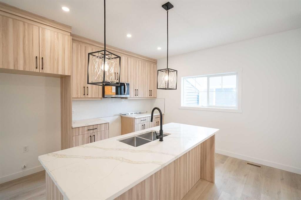 90 Baysprings Terrace Sw, Airdrie, AB - Indoor Photo Showing Kitchen With Double Sink