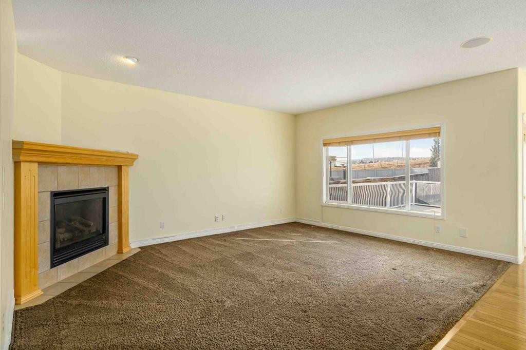 153 Kincora Bay Nw, Calgary, AB - Indoor Photo Showing Living Room With Fireplace