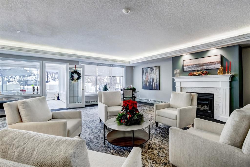203-2144 Paliswood Road Sw, Calgary, AB - Indoor Photo Showing Living Room With Fireplace