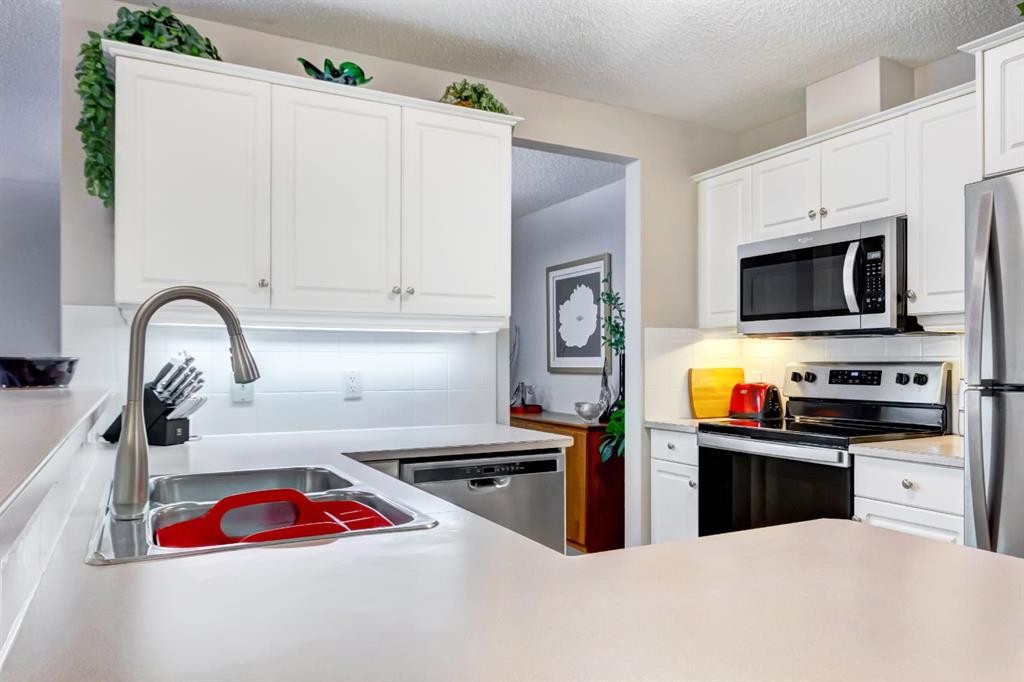 203-2144 Paliswood Road Sw, Calgary, AB - Indoor Photo Showing Kitchen With Stainless Steel Kitchen With Double Sink With Upgraded Kitchen