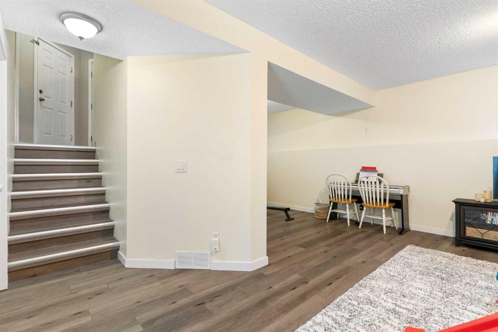 20 Willow Brook Crescent Nw, Airdrie, AB - Indoor Photo Showing Other Room With Fireplace