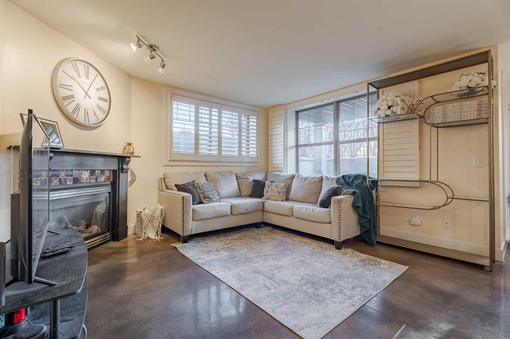 101-3704 15A Street Sw, Calgary, AB - Indoor Photo Showing Living Room With Fireplace