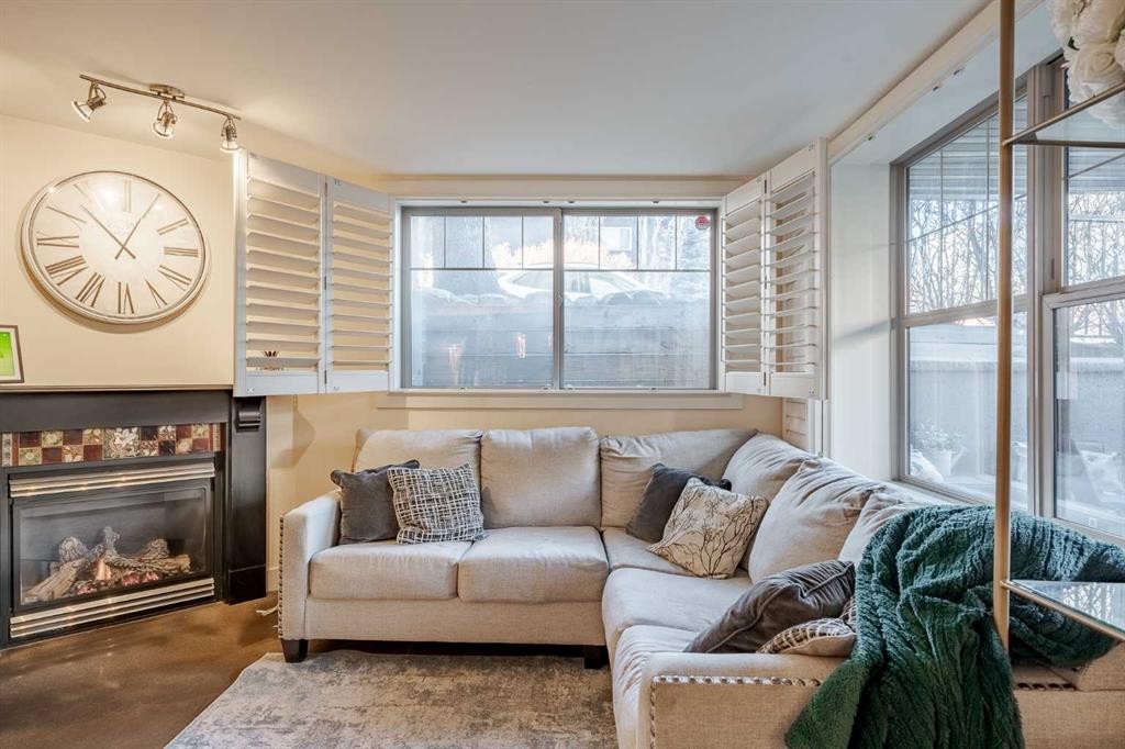 101-3704 15A Street Sw, Calgary, AB - Indoor Photo Showing Living Room With Fireplace
