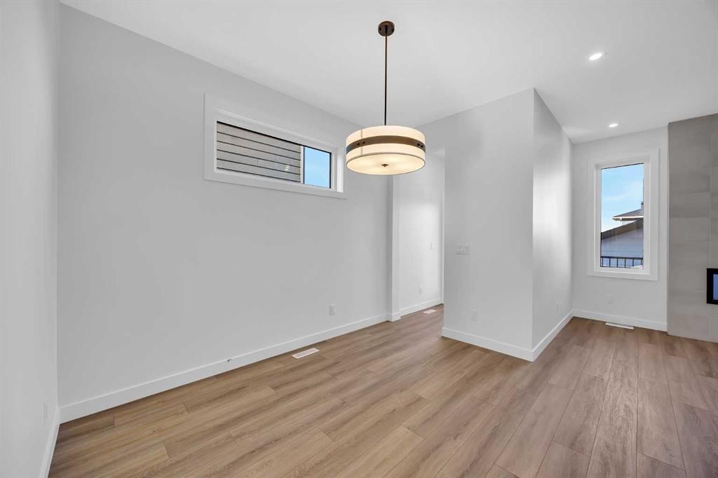 14 Versant Path Sw, Calgary, AB - Indoor Photo Showing Other Room With Fireplace