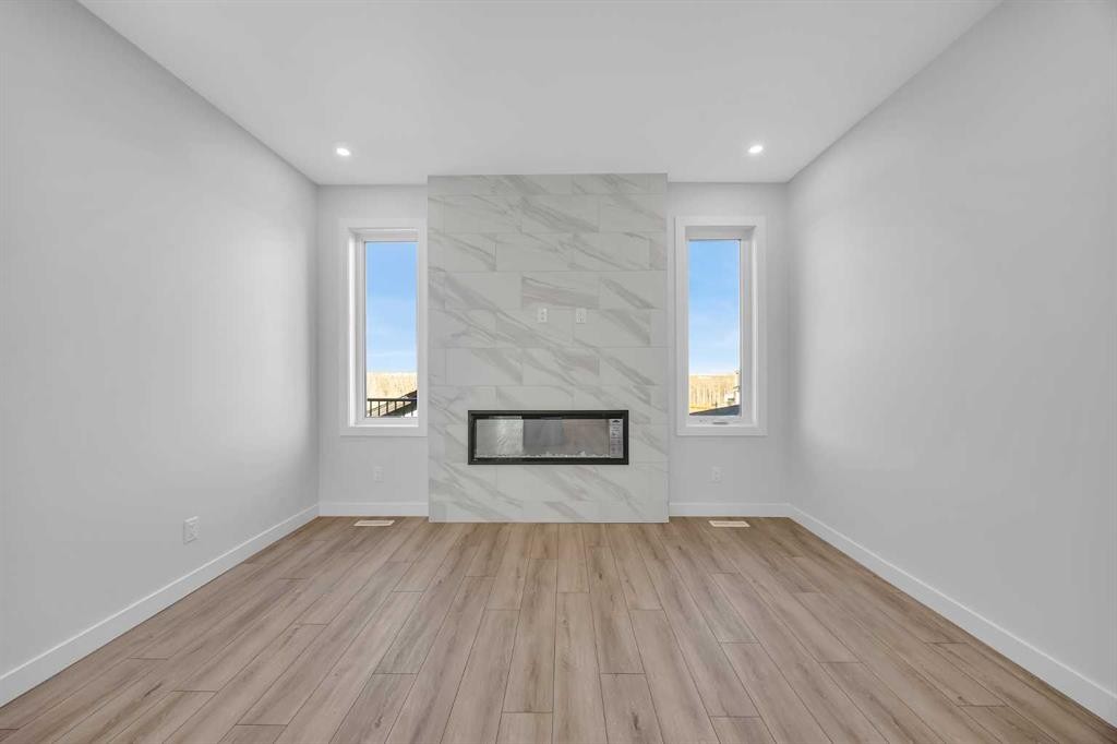 26 Versant Path Sw, Calgary, AB - Indoor Photo Showing Living Room With Fireplace