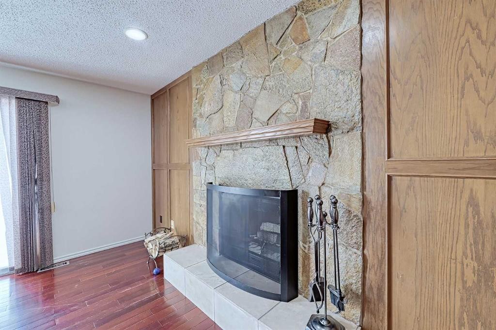 48 Bernard Way Nw, Calgary, AB - Indoor Photo Showing Other Room With Fireplace