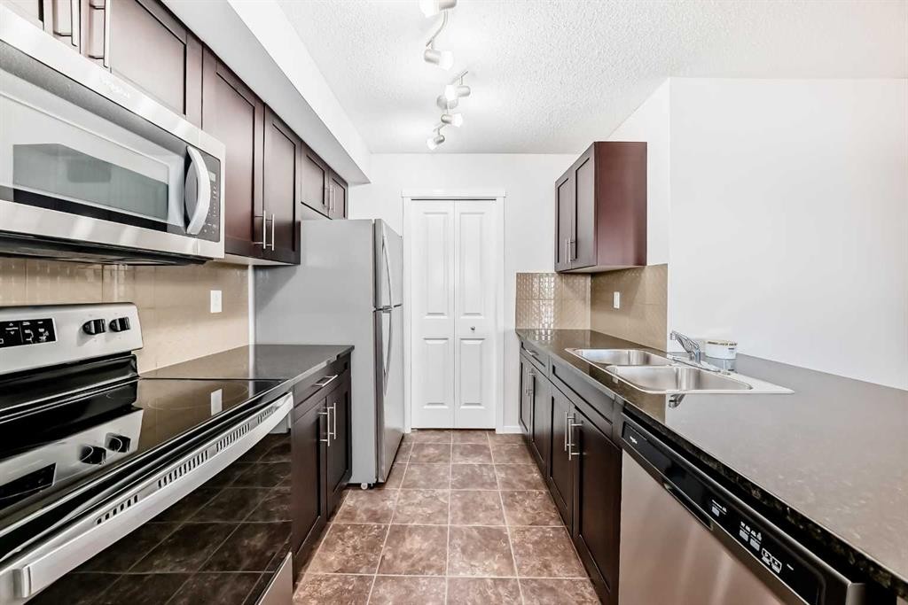 2324-81 Legacy Boulevard Se, Calgary, AB - Indoor Photo Showing Kitchen With Stainless Steel Kitchen With Double Sink With Upgraded Kitchen