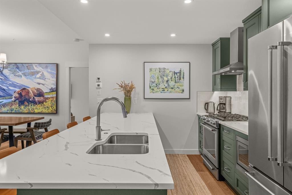 313-1408 Spring Creek Gate, Canmore, AB - Indoor Photo Showing Kitchen With Stainless Steel Kitchen With Double Sink With Upgraded Kitchen