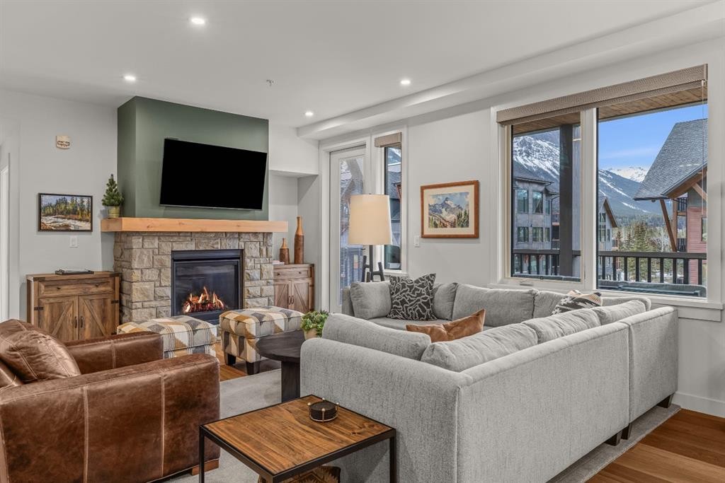 313-1408 Spring Creek Gate, Canmore, AB - Indoor Photo Showing Living Room With Fireplace