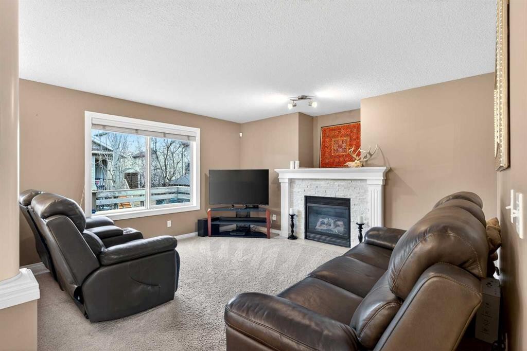 69 Elkton Way Sw, Calgary, AB - Indoor Photo Showing Living Room With Fireplace