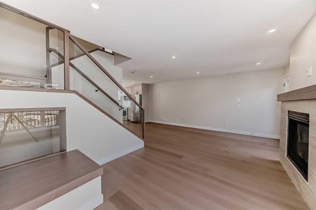 115-1330 1St Avenue, Canmore, AB - Indoor Photo Showing Other Room With Fireplace