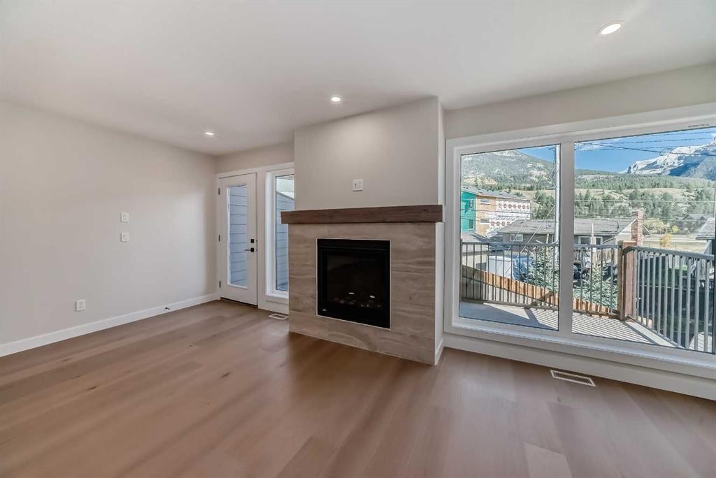 115-1330 1St Avenue, Canmore, AB - Indoor Photo Showing Living Room With Fireplace