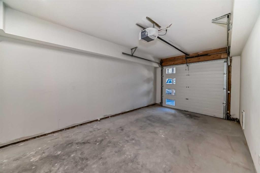 115-1330 1St Avenue, Canmore, AB - Indoor Photo Showing Garage