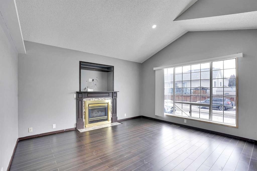 131 Martinridge Grove Ne, Calgary, AB - Indoor Photo Showing Living Room With Fireplace